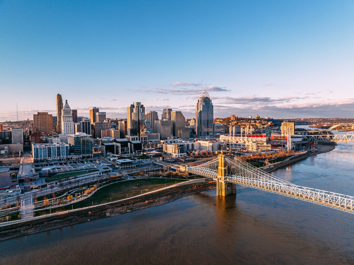 a bridge over a body of water with a city in the background
