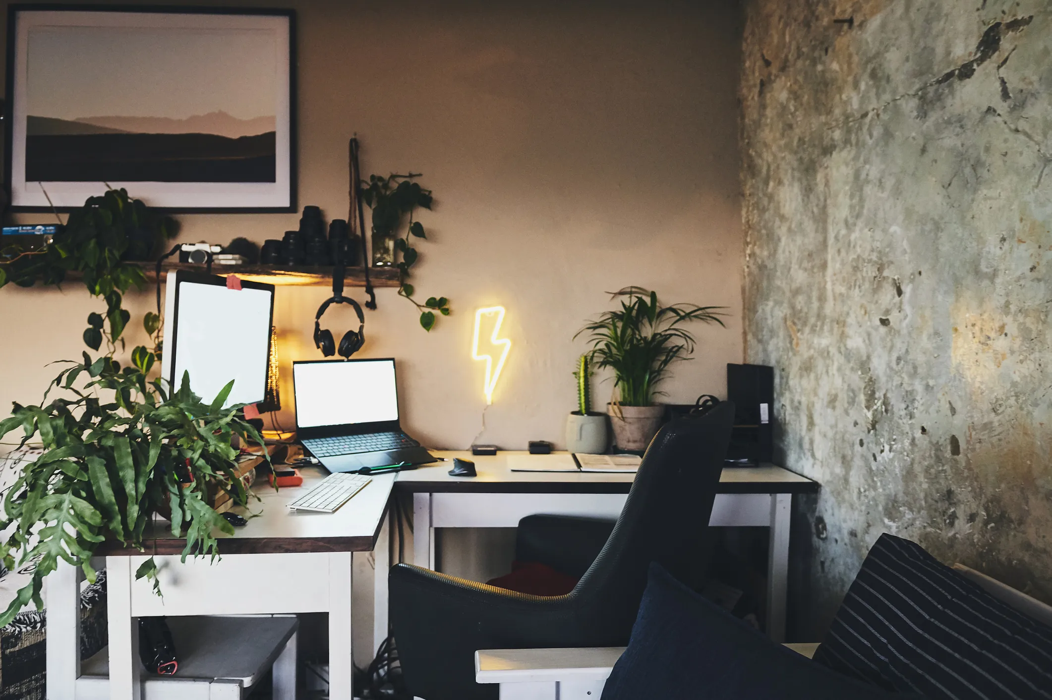 Home office desk with laptop, monitor, and multiple devices plugged into a power strip in a Cincinnati house